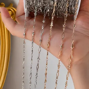 Close-up detail of DIY metal chain, star and diamond links for jewelry making accessories.