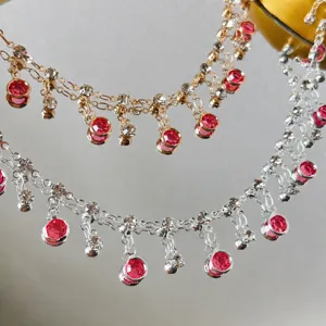 Detailed view of DIY pink rhinestone tassel chain, fine metal links and crystal drop elements.