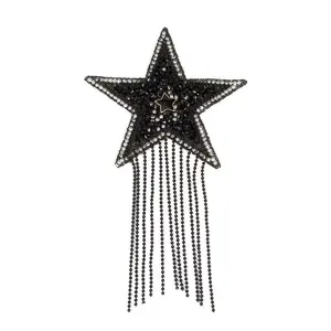 Close-up detail of black star rhinestone fringe patch accessory, sparkling beaded tassel.