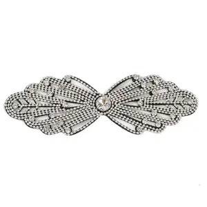 Detailed view of sparkly rhinestone bow patch applique, sparkling crystal craft DIY accessory.