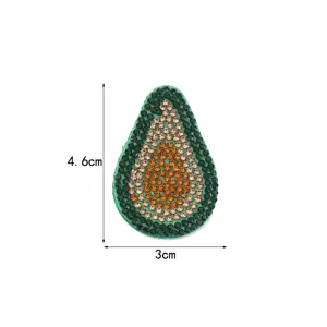 Detailed close-up of the green avocado rhinestone patch showing sparkling crystal details and clean edges.