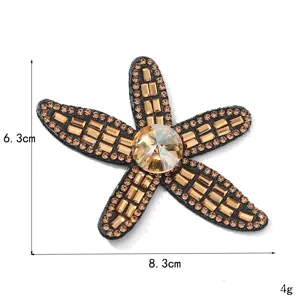 Squisita applicazione accessorio stella marina in strass champagne per abbigliamento e copricapo.