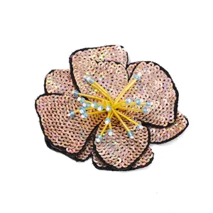 Sequin flower patch close-up, rose gold embroidered fabric patch, sparkling diy craft accessory.