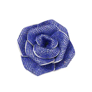 Blue rhinestone rose brooch detail, sparkling crystal flower apparel accessory for women.