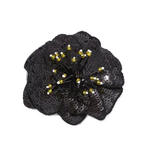 Black sequin flower patch detail, sparkling bead stamens for DIY craft, clothing decoration.