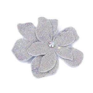 Close-up view of a large double-layered 3D rhinestone flower accessory with sparkling crystals.