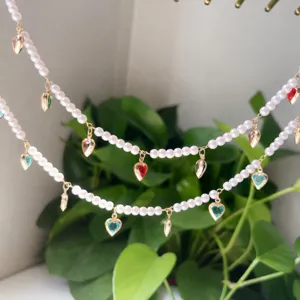 Detailed view of pearl beaded chain with heart gemstone pendants, elegant handmade diy jewelry.