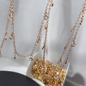 Detailed closeup view of delicate rose gold DIY chain with shimmering crystal pendants.