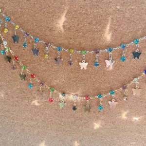 DIY jewelry accessories featuring colorful rhinestones and cute butterfly charms necklace.