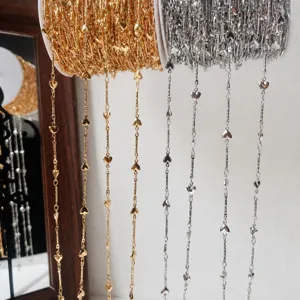 Gold and silver heart link chains on spools for DIY jewelry making and craft design.