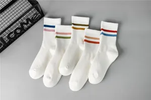 Detailed close-up of white mid-tube socks featuring colorful double stripes, soft and breathable.