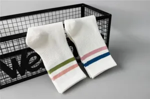 White mid-tube women socks featuring colored stripes, breathable sports socks for daily wear.