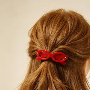 Cute red glasses shaped hair clip for women, creative retro hair styling accessory for styling.