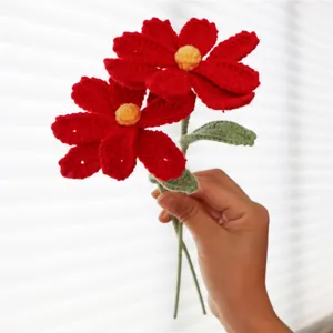 Handmade crochet red cosmos flower detail view, exquisite knitted floral home decor accessory.