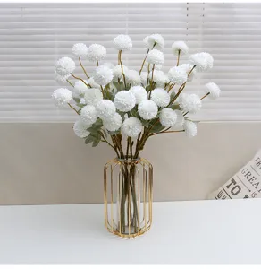 Artificial white dandelion chrysanthemum flowers in gold wire vase for home decor party.