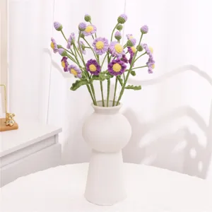 Handcrafted knitted wool daisy flower bouquet for cozy home decoration and stylish interior styling.