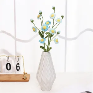 Handmade knitted daisy flower bouquet with white ceramic vase, perfect for home desktop decor.