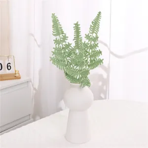 Knitted wool fern leaf home decor flower, handmade green plant bonsai for interior display.