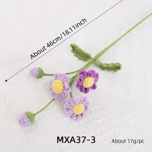 Handmade crochet daisy fern flower branch, knitted botanical home decoration accessory detail.