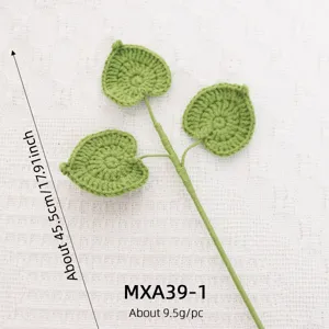 Close-up of handmade crochet green leaf branch detail, soft wool material, perfect decor.