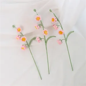 Handmade crochet flower detail, exquisite pink yarn bouquet stem showing delicate craft quality.
