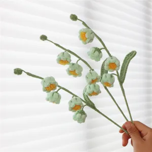 Handcrafted crochet lily of the valley flower bouquet, perfect artificial floral gift for home decor.