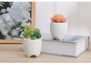 Planta suculenta artificial en maceta de cerámica blanca, decoración de escritorio.