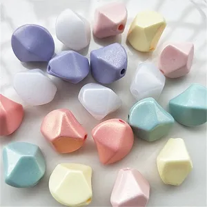 Detailed close-up of colorful acrylic irregular diamond beads with shimmer effect for DIY jewelry.