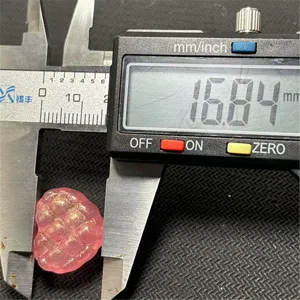Close-up detail shot showing the pink waffle heart bead size measurement with digital caliper.