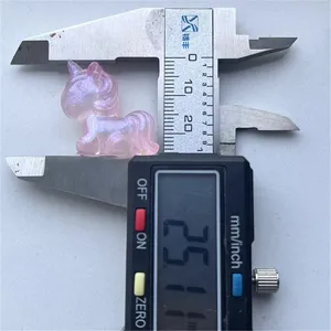 Gros plan de perle de licorne en résine accessoire de bricolage mesuré avec pied à coulisse.