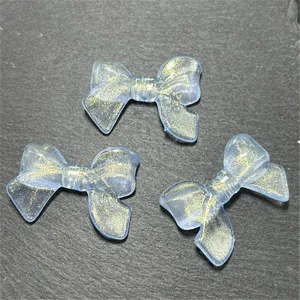 Acrylic translucent gold glitter bow shaped vertical hole loose beads detail display.