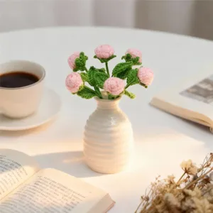 Handmade crochet mini rose bouquet in ceramic vase, delicate artificial flower home decor.