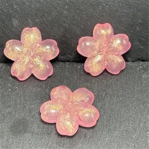 Pink glitter cherry blossom DIY resin beads for phone charms, keychains, and jewelry making.