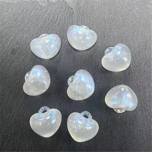 Closeup of acrylic iridescent heart beads with hanging hole, perfect for DIY crafts.