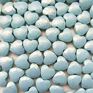 Close-up detail shot of light blue mermaid heart acrylic beads, faceted DIY craft jewelry accessory.