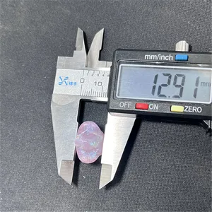 Close-up detail shot of a mermaid glow pentagram bead being measured with digital caliper.