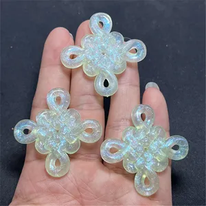 Close-up detail of iridescent luminous Chinese knot resin DIY craft charms and accessories.