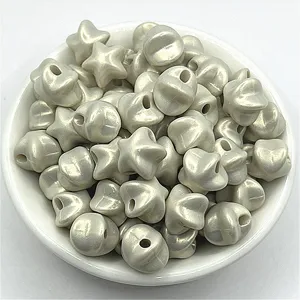 Close-up view of glossy pearly star shaped beads in a bowl for handmade DIY jewelry details