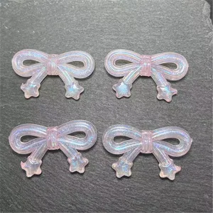 Close-up detail of translucent pink bow resin DIY beads with star tails, perfect for phone charms.