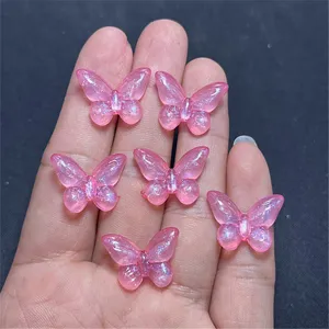 Pink glitter resin butterfly charms detailed view for DIY phone chains and craft accessories.