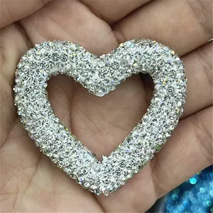 Close-up detail of sparkling rhinestone paved heart charm, perfect for DIY crafts and phone decor.