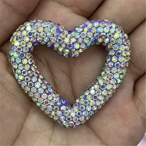 Close-up detail of large rhinestone heart clay DIY charm pendant for phone chains and keychains.