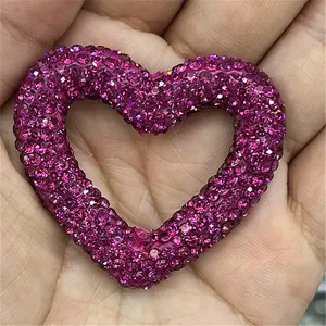 Close-up detail of a sparkly rhinestone heart craft charm, perfect for DIY jewelry making accessories.