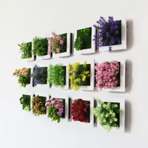 Parete con cornice per piante artificiali sospese con fiori succulenti colorati.