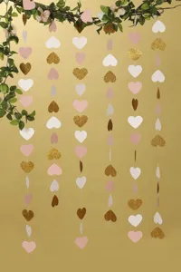 Heart paper garland detail view, gold glitter, pink and white hearts for party decor.
