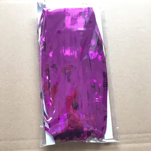 Fringe curtain detail showing shiny purple tinsel material inside transparent packaging.