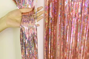 Close-up detail shot of rose gold metallic tinsel fringe curtain for party backdrop decor.