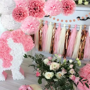 Rose gold birthday party decoration set with paper pom pomes, tassel garlands, and festive banners.