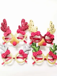 Christmas reindeer antler glasses details with polka dot bows and red nose holiday party props.