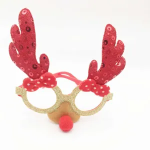 Close-up detail of Christmas reindeer antler glasses with glitter frame and red bows.